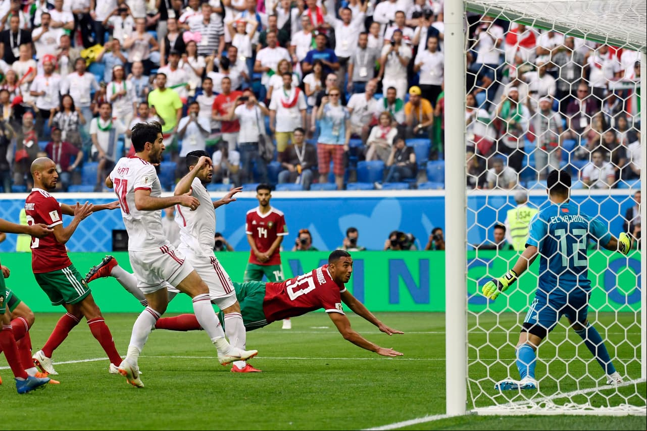 Morocco's forward Aziz Bouhaddouz (C) scores an own goal during the Russia 2018 World Cup Group B football match between Morocco and Iran at the Saint Petersburg Stadium in Saint Petersburg on June 15, 2018. (Photo by CHRISTOPHE SIMON / AFP) / RESTRICTED TO EDITORIAL USE - NO MOBILE PUSH ALERTS/S (Photo credit should read CHRISTOPHE SIMON/AFP/Getty Images)